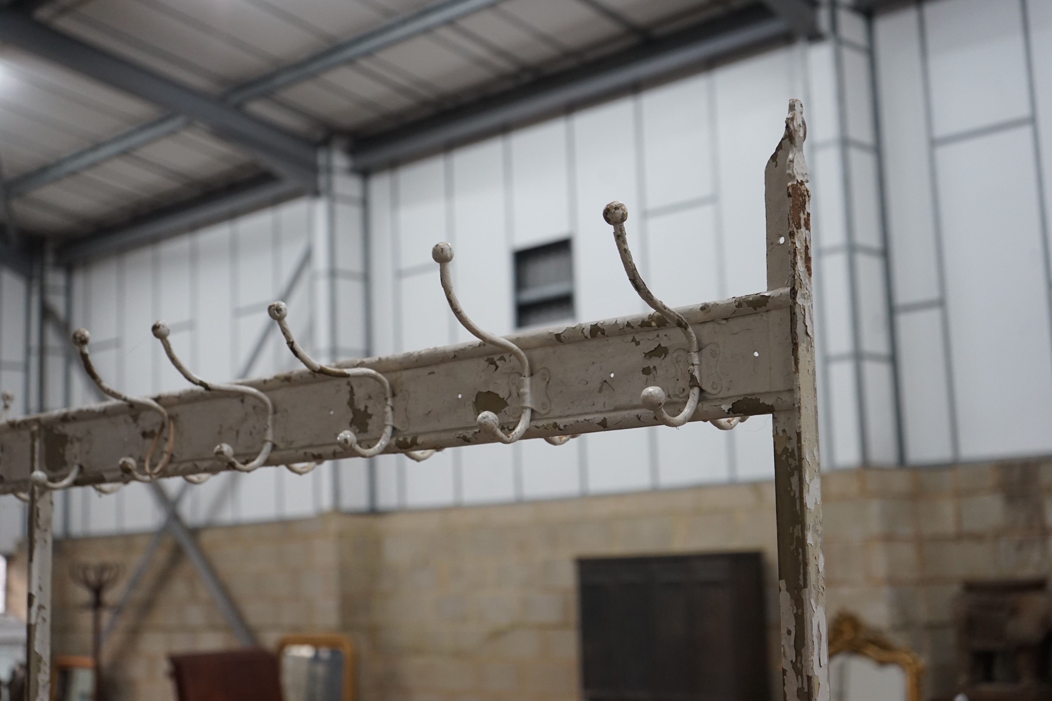 A vintage wrought iron coat and stick stand, width 200cm, height 206cm